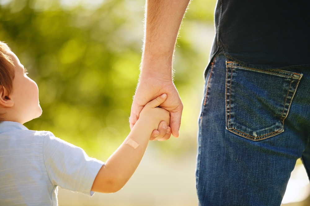 Photo of A Father Holding Hands